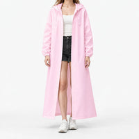 Studio front view of the pink hooded raincoat worn open over a white ribbed top and black shorts, with elastic cuffs. 7