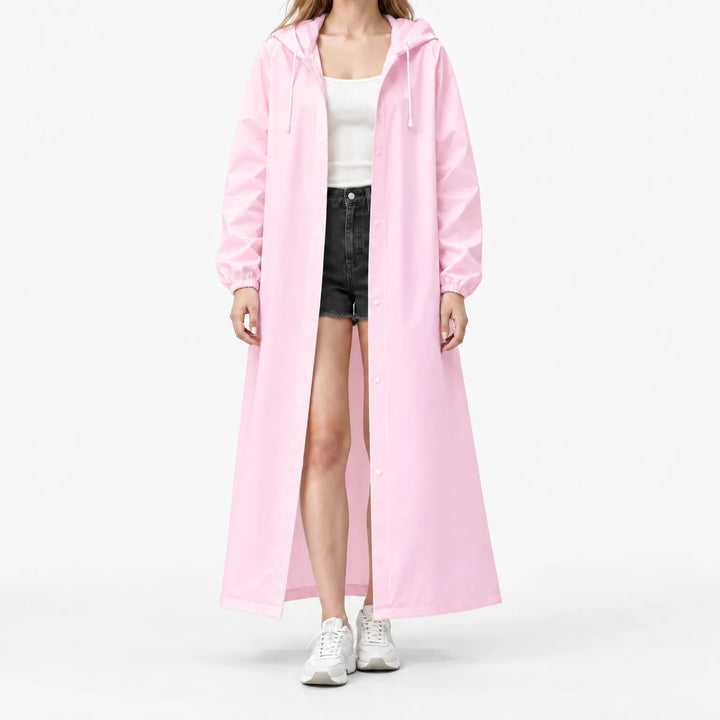 Studio front view of the pink hooded raincoat worn open over a white ribbed top and black shorts, with elastic cuffs. 7