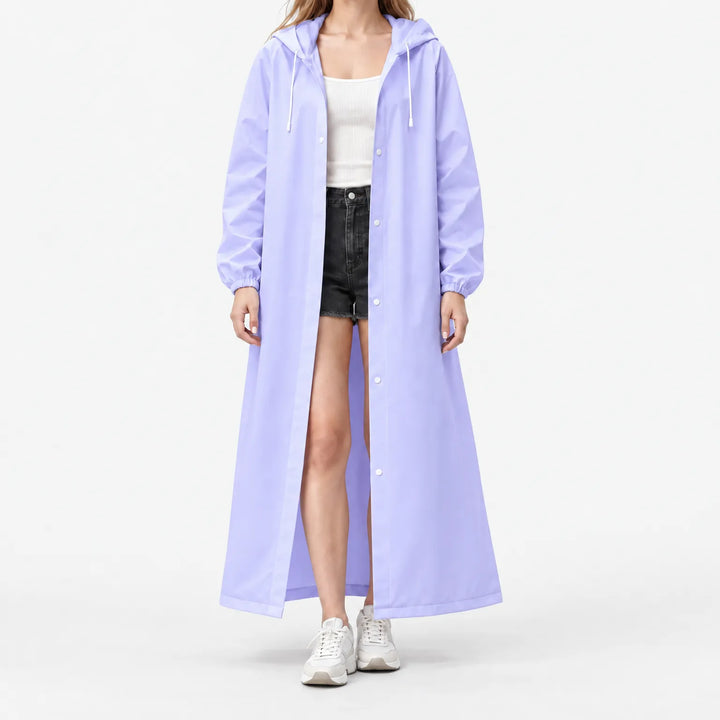 Studio front view of the lilac hooded raincoat worn open over a white ribbed top, black shorts and white sneakers. 9