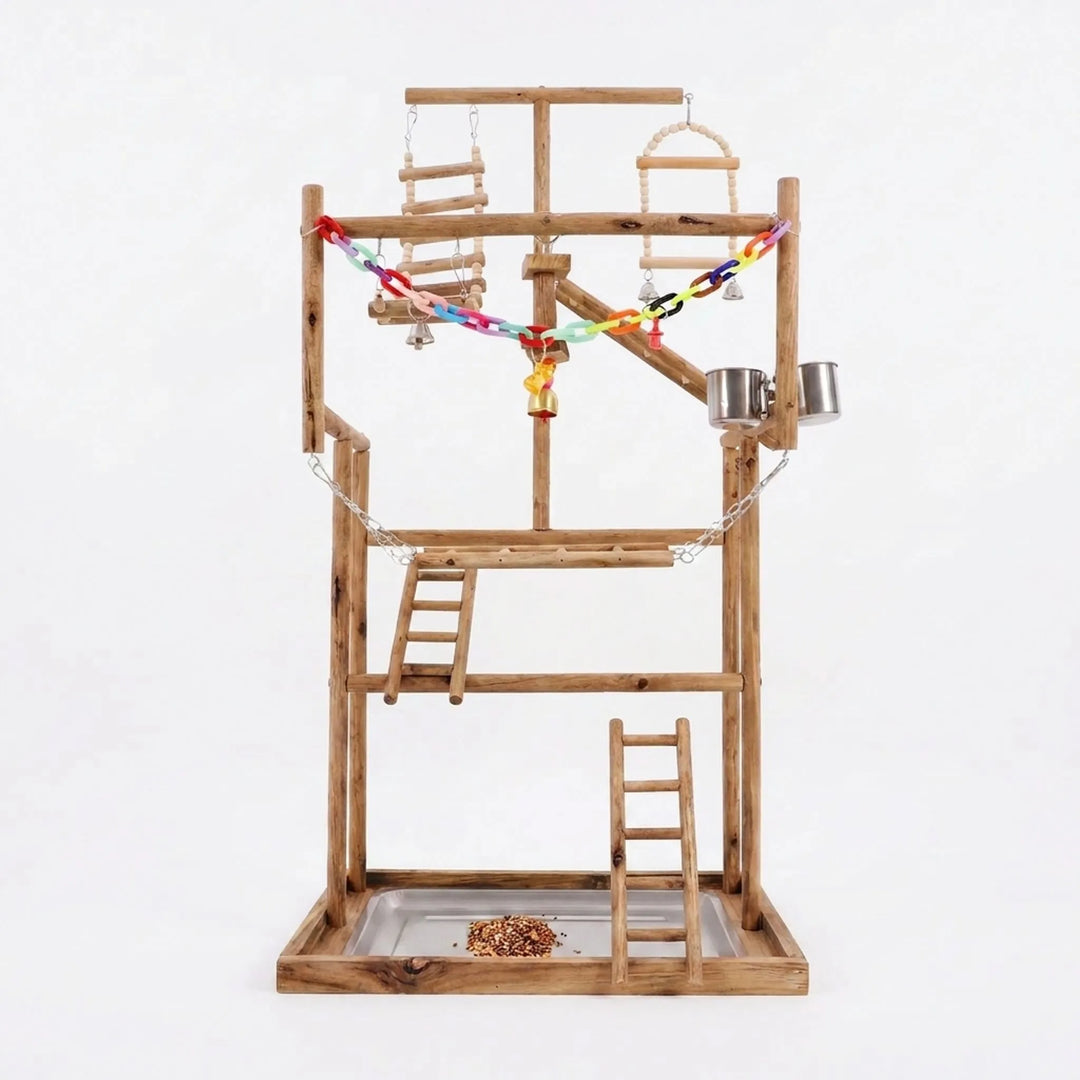 Multi-level wooden bird playground on a plain white background, with ladders, swings, a colourful chain, bells, steel cups and a seed tray. 1