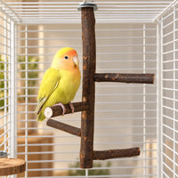 Yellow and orange lovebird perching on a lower branch of the wooden perch inside a white wire cage. 2