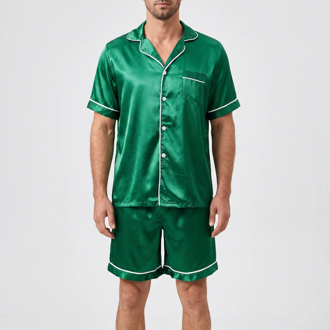 Model wearing the pyjama set in glossy green satin with white piping and white buttons, front view. 6