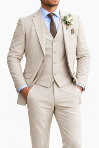 Close-up of a beige textured three-piece suit with light blue shirt, brown paisley tie and white rose buttonhole 6