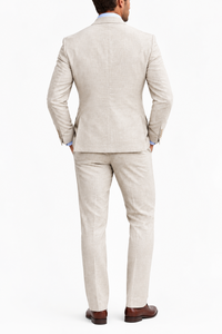 Back view of a full beige suit worn with a light blue shirt and brown leather shoes 7