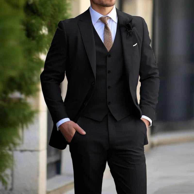 Model wearing the suit in black, with white shirt, brown tie and a dark lapel flower 3