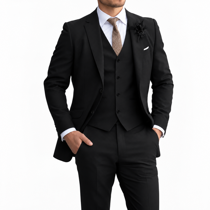 Model in a black three-piece suit with white shirt, brown tie and dark buttonhole, against a plain white background 5