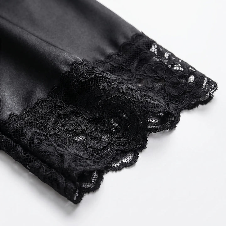 Close-up detail of the scalloped black floral lace trim on the satin fabric edge. 5