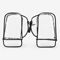 Pair of clear plastic handlebar muffs with black binding, joined by a strap, laid flat against a plain white background. 2