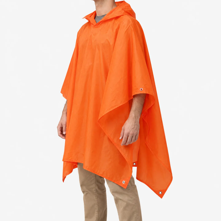 Three-quarter side view of the orange poncho worn over a grey t-shirt, showing the pointed hem and metal eyelets. 4