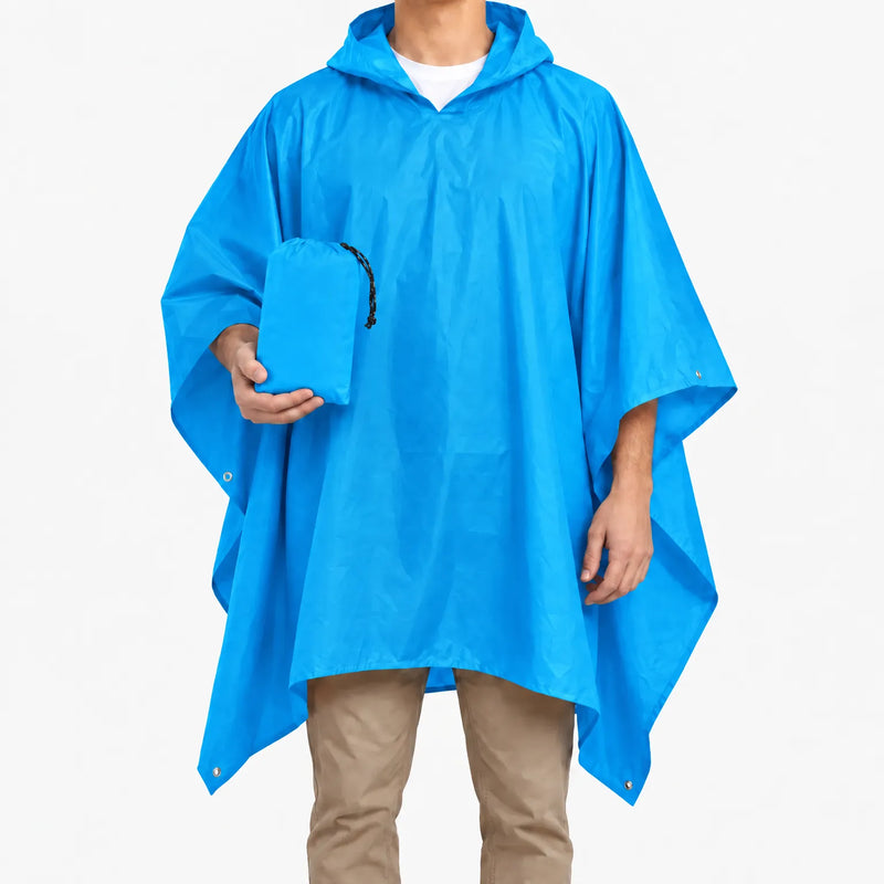Bright blue version of the hooded poncho worn on a model, who holds the matching blue drawstring pouch. 9