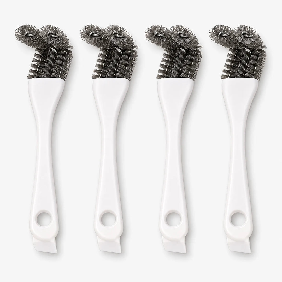Four white-handled cage brushes standing upright side by side, each with grey bristle heads and a hanging hole at the base. 1