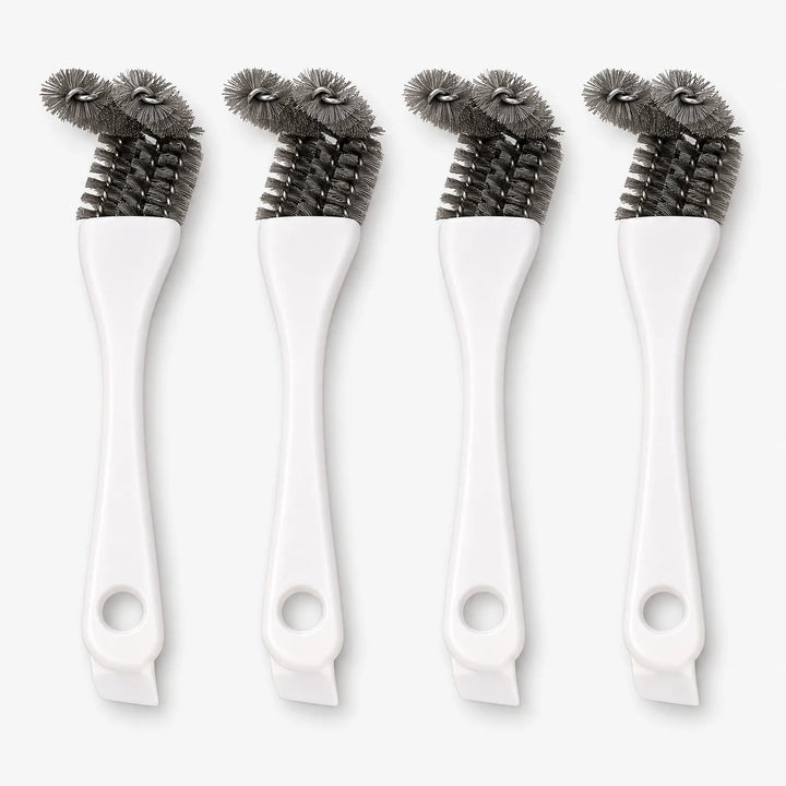Four white-handled cage brushes standing upright side by side, each with grey bristle heads and a hanging hole at the base. 1