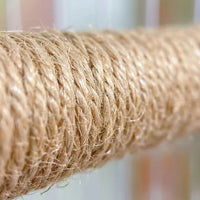 Close-up of the twisted natural fibre rope wound tightly around the perch, showing its rough, fibrous texture against a blurred background. 3