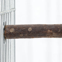 Close-up of a bark-covered wooden perch fixed to a metal cage wire panel with a round washer, showing knots and grain. 3