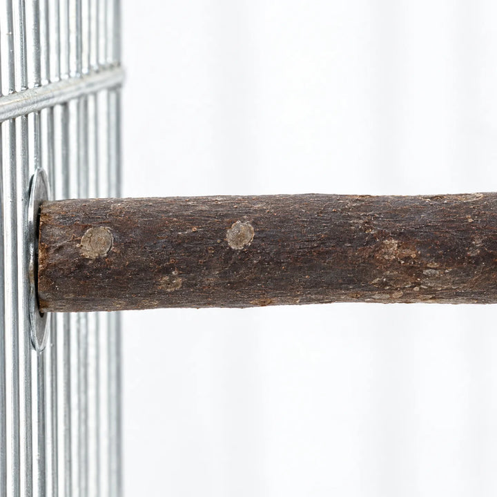 Close-up of a bark-covered wooden perch fixed to a metal cage wire panel with a round washer, showing knots and grain. 3