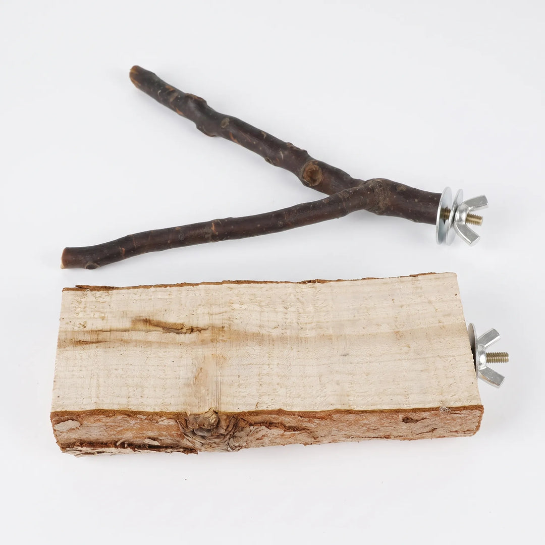 Top-down flat lay of a forked wooden branch perch beside a rough-cut wooden block perch, both with metal wing nut fittings. 4