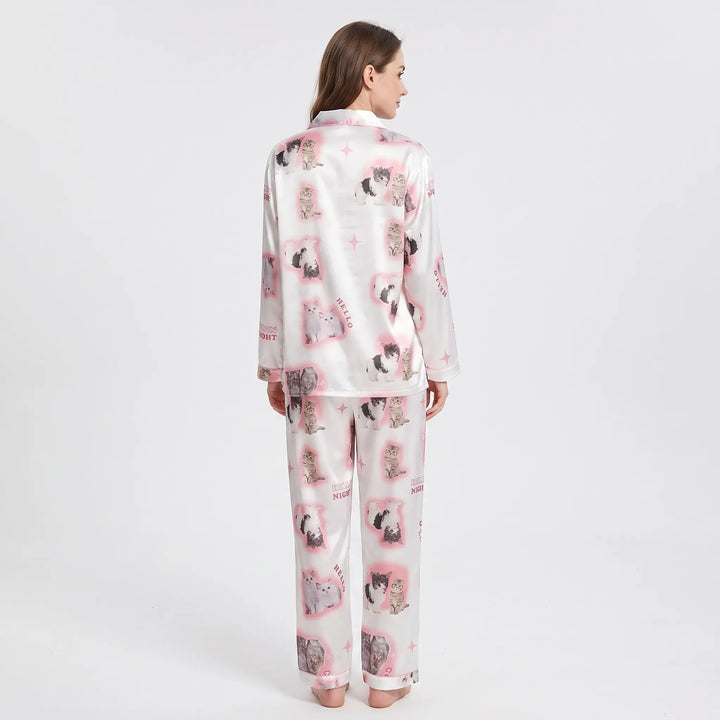 Back view of a model wearing the satin pyjama set, showing the kitten print across the shirt and trousers. 3