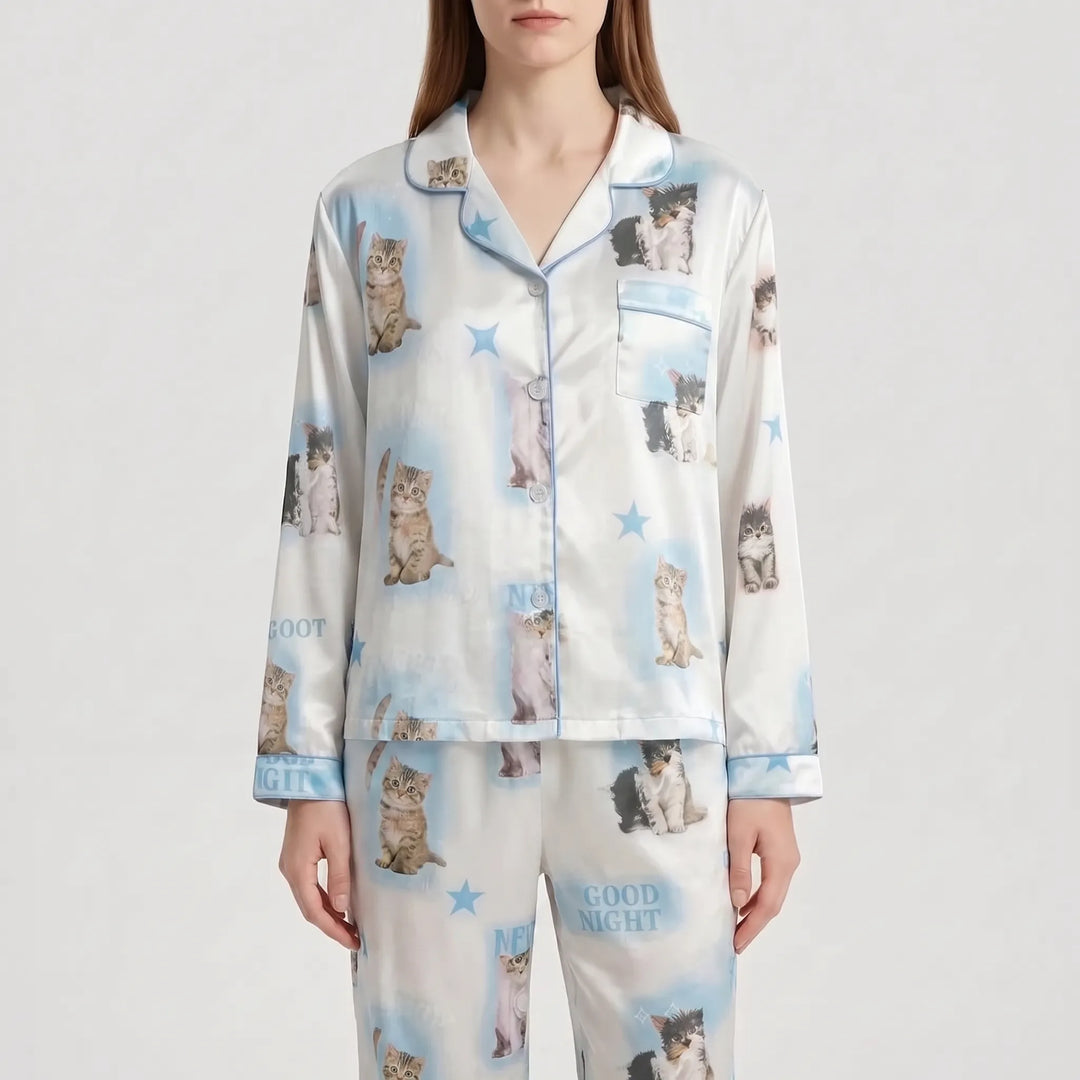 Front view of the model in the alternative light blue colourway of the kitten-print satin pyjama set with stars. 7