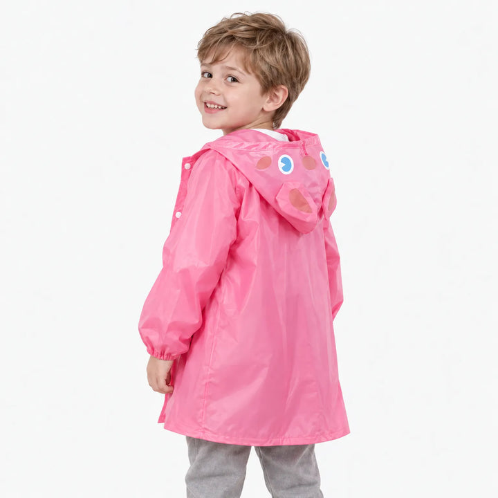 Back view of a smiling boy in the pink rain jacket, showing the rabbit hood with printed eyes and ears. 4