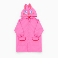 Pink rabbit rain jacket laid flat, with ears and a smiling face on the hood and red-trimmed pockets. 9