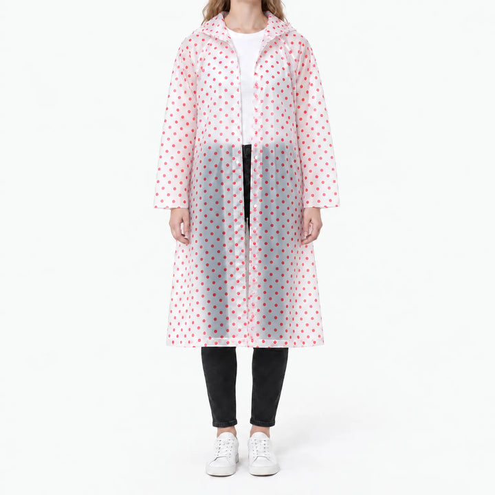 Front view of the translucent raincoat with red polka dots, snap buttons visible, worn over a white tee and black jeans. 10