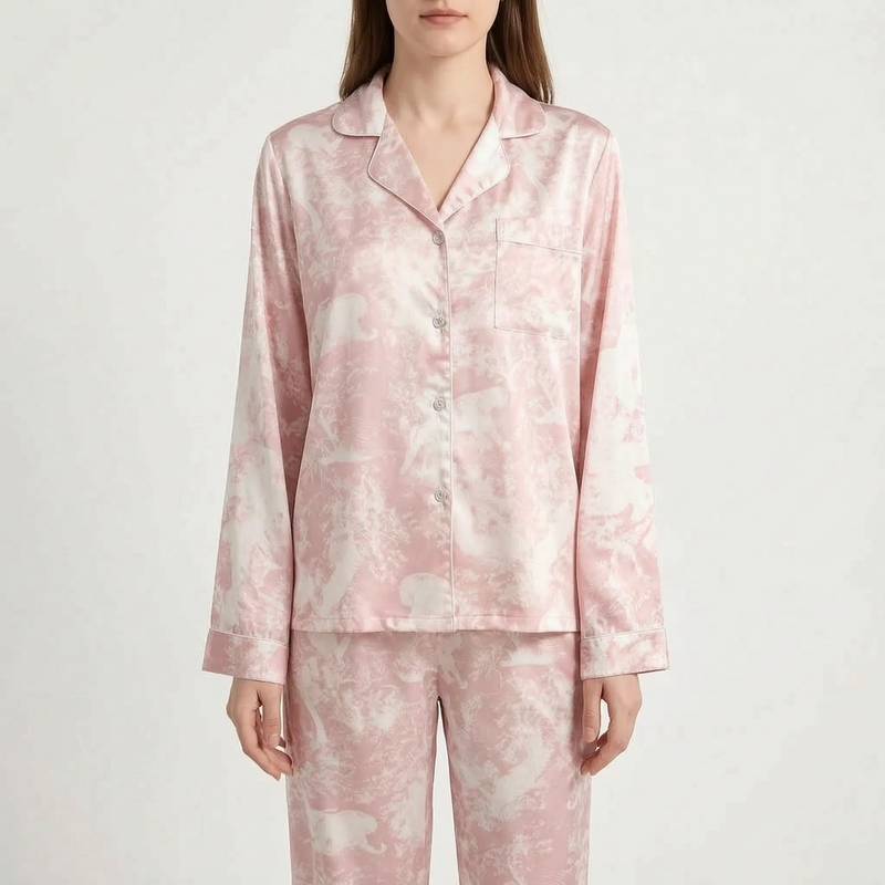 Front view of a model in the long-sleeve pink and cream printed pyjama shirt, buttoned up with piped cuffs and chest pocket. 7