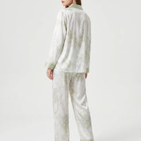 Back view of the model wearing the long sleeve pyjama set, showing the marbled green print and green cuffs. 3