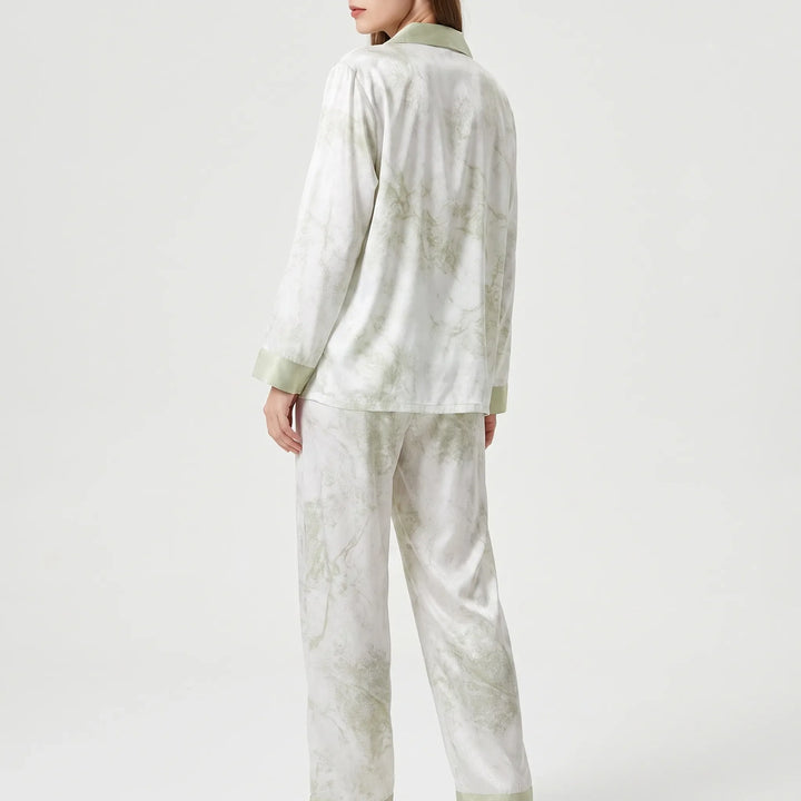 Back view of the model wearing the long sleeve pyjama set, showing the marbled green print and green cuffs. 3