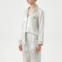Side view of the model in the pyjama shirt with chest pocket, notched collar, green cuffs and elasticated trouser waistband. 4