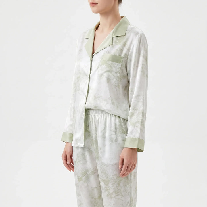 Side view of the model in the pyjama shirt with chest pocket, notched collar, green cuffs and elasticated trouser waistband. 4