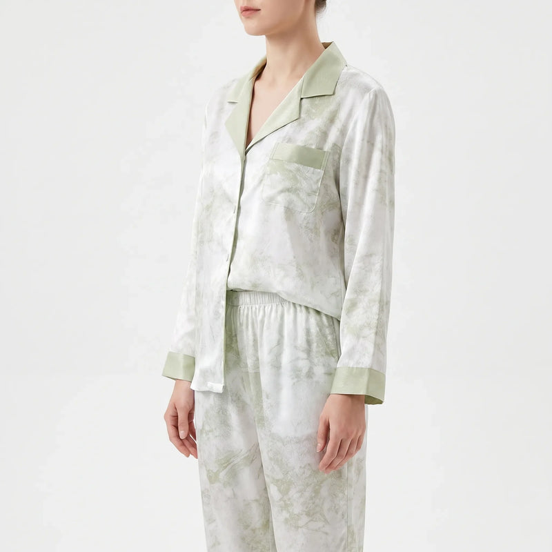 Side view of the model in the pyjama shirt with chest pocket, notched collar, green cuffs and elasticated trouser waistband. 4