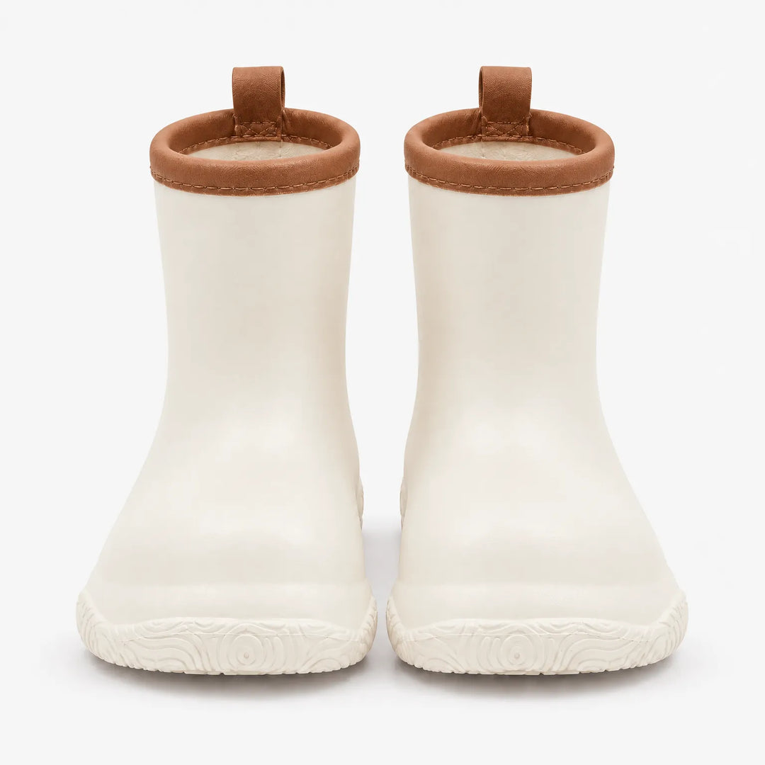 Front view of a pair of cream wellies with brown stitched collars, brown pull loops and a swirl-patterned sole. 10