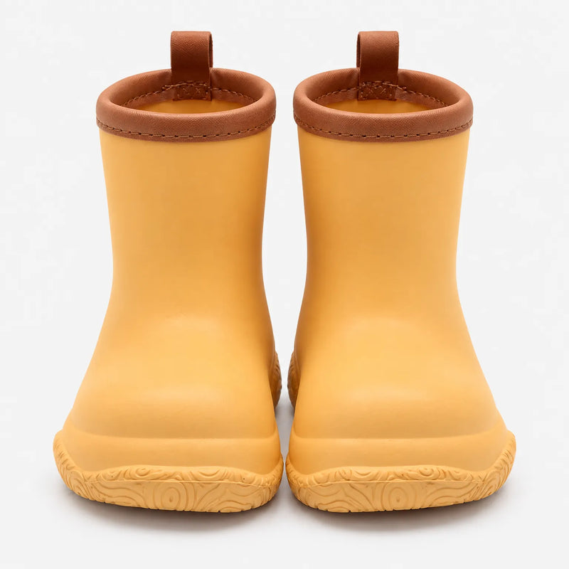 Front view of a pair of yellow-orange wellies with brown stitched collars, brown pull loops and a swirl-patterned sole. 11
