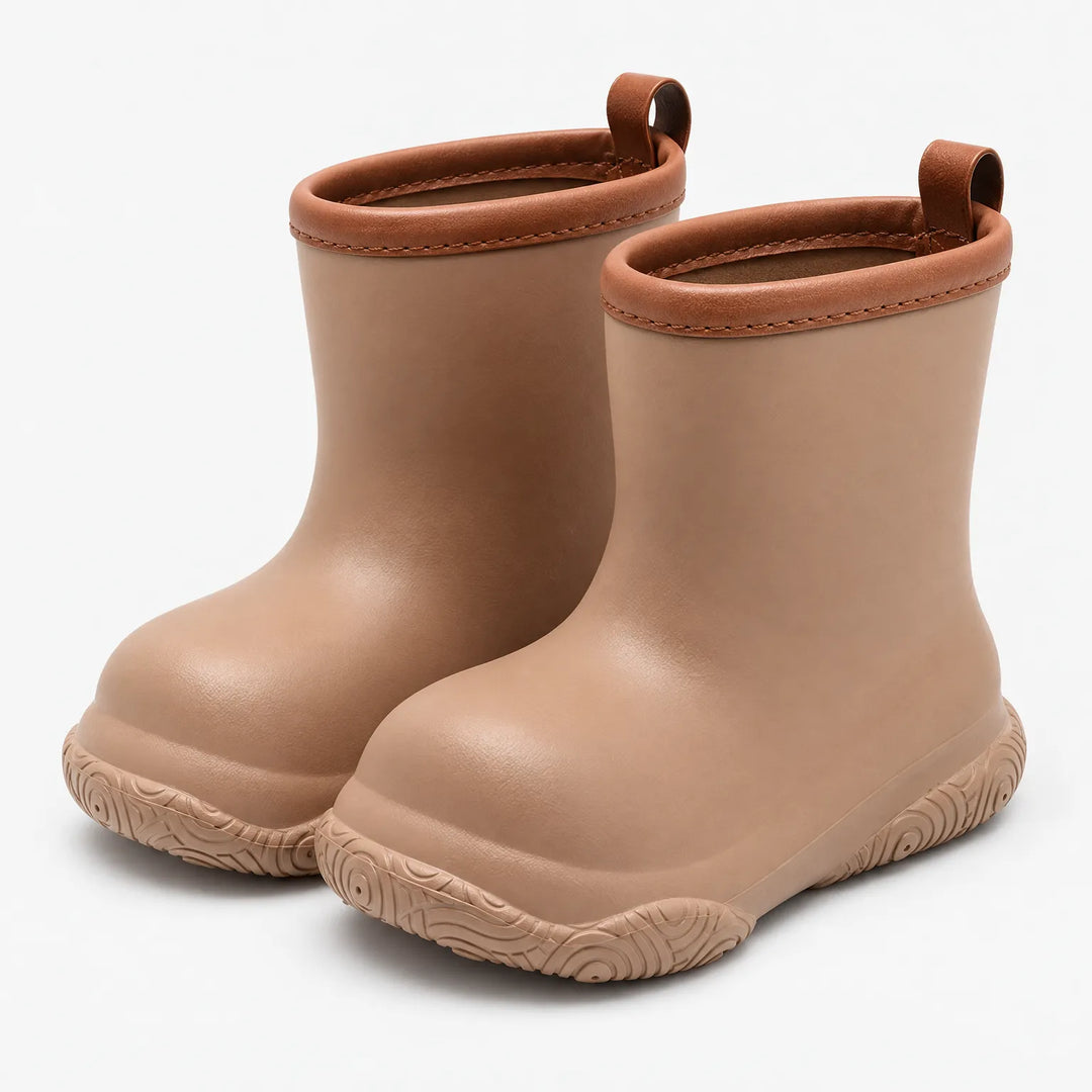 Pair of tan pull-on wellies with brown stitched collars and pull loops, shown at an angle on a plain white background. 2