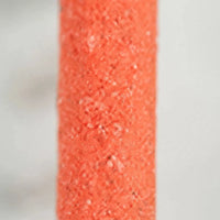 Close-up of the coarse, sandy orange surface of the perch, showing its rough grainy texture. 4