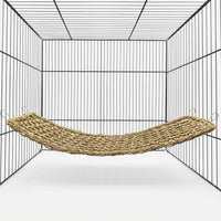 Woven natural-fibre hammock hung by four metal clips inside an empty wire cage, shown against a plain white background. 1