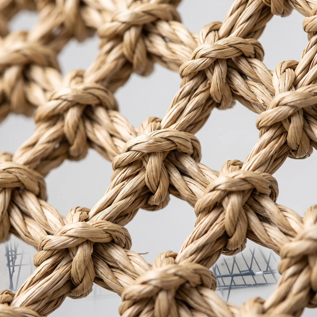 Close-up of the hammock's knotted, twisted natural-fibre weave, showing the open diamond-shaped mesh and texture of the strands. 3