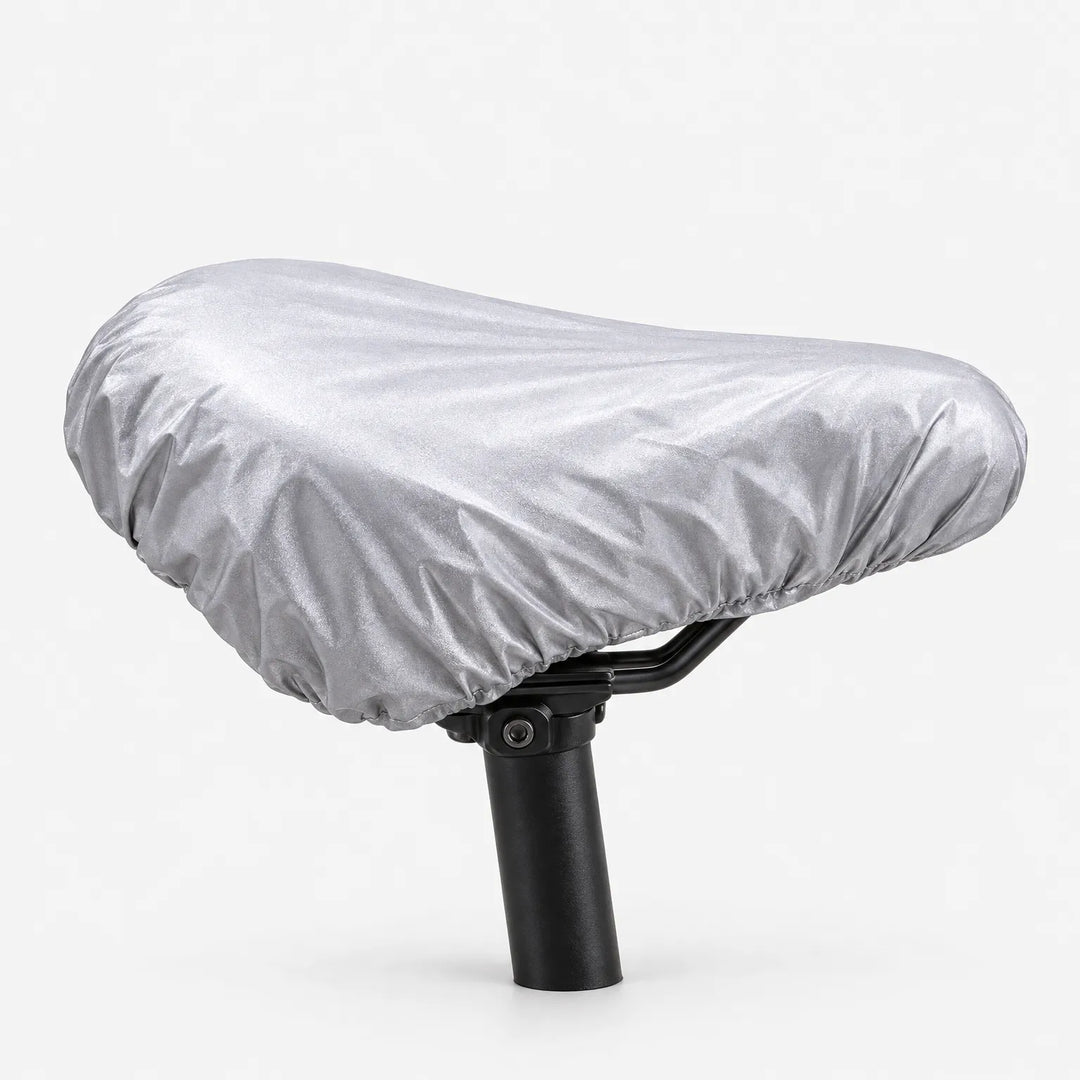 Reversed silver-grey side of the saddle cover stretched over a saddle on a black seatpost, white background. 4
