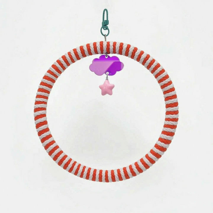 Ring swing wrapped in red-orange and white rope, with a green clip, a purple mirrored cloud charm and a pink star. 6