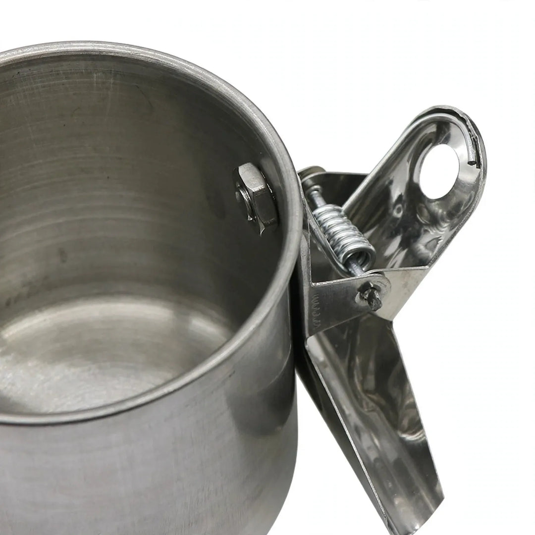 Close-up of the spring clip and bolt attached to the side of a steel cup, seen from above. 3