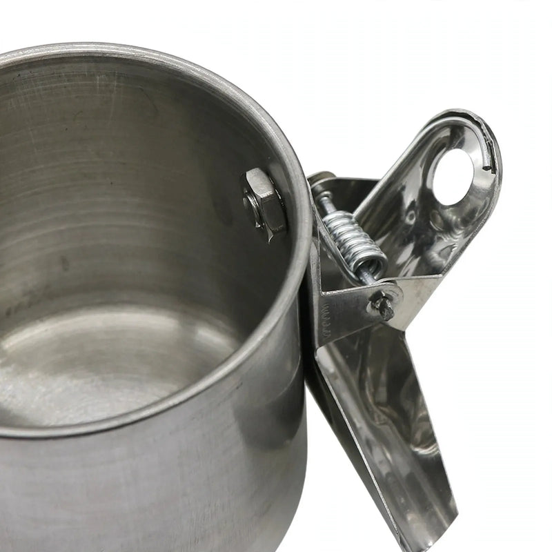 Close-up of the spring clip and bolt attached to the side of a steel cup, seen from above. 3