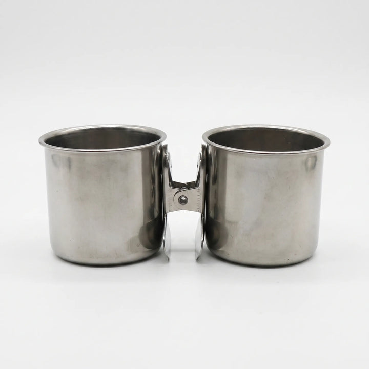 Two steel cups placed side by side on a white background, their clips facing each other in the middle. 5