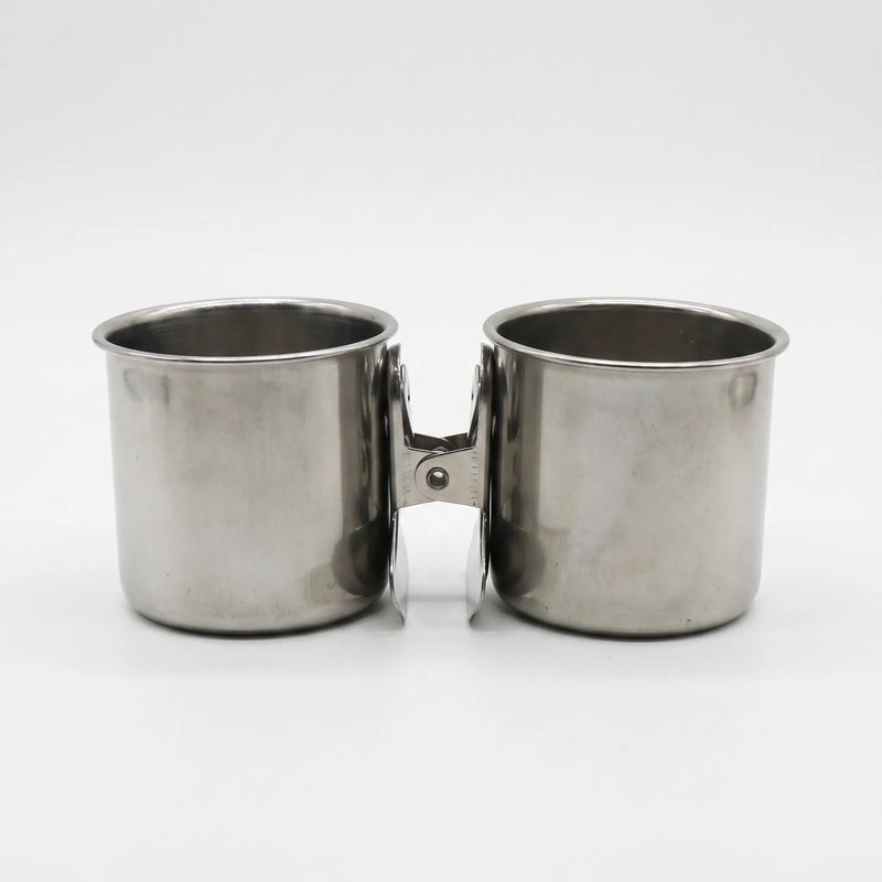 Two steel cups placed side by side on a white background, their clips facing each other in the middle. 5
