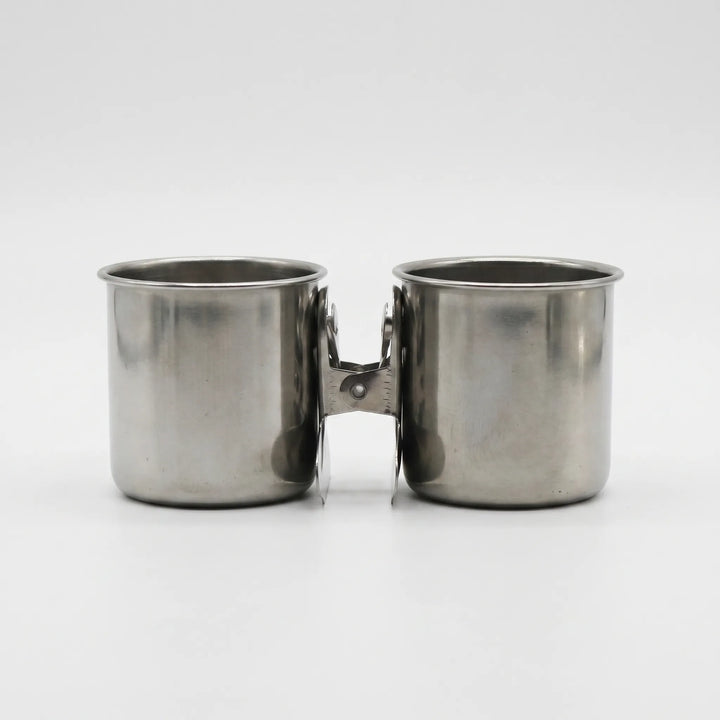 Pair of steel cups with their clips pressed together between them, shown from the front on white. 7