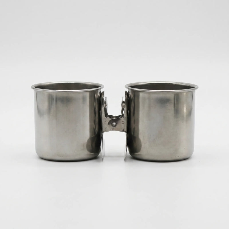 Pair of steel cups with their clips pressed together between them, shown from the front on white. 7