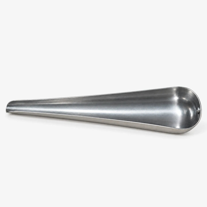 Empty tapered metal scoop lying on its side against a white background, showing the open channel and narrow spout. 4