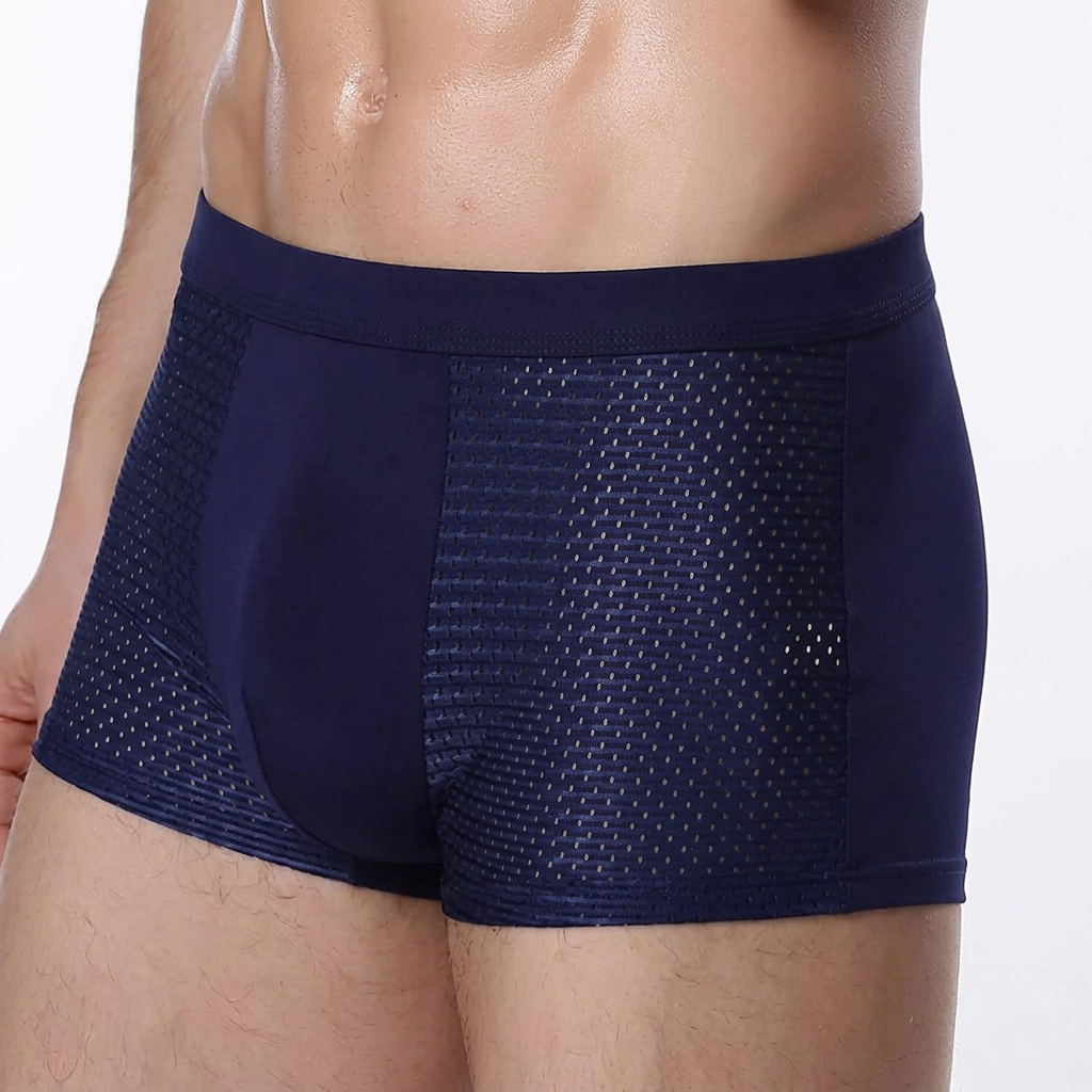Close-up of a model wearing navy boxers, showing the mesh side panels and smooth plain front 5