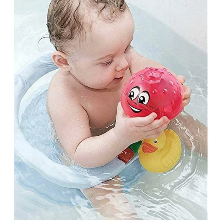 Bath toy ball with light effects, fountain and motorised drive for children