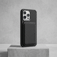 Black woven-texture case with card pocket, silver phone camera visible, standing on a rough concrete block 7