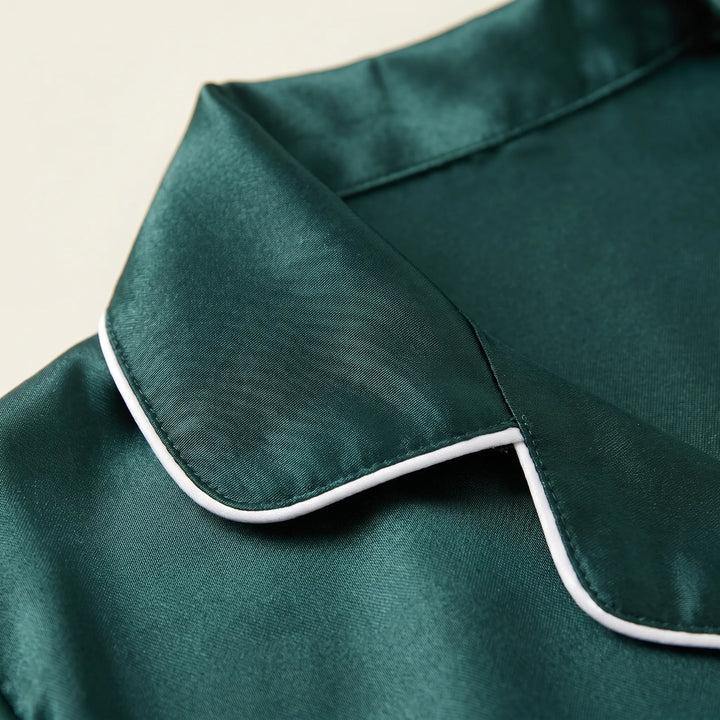 Close-up of the satin collar in dark green with white piping along the lapel edge and visible stitching. 5